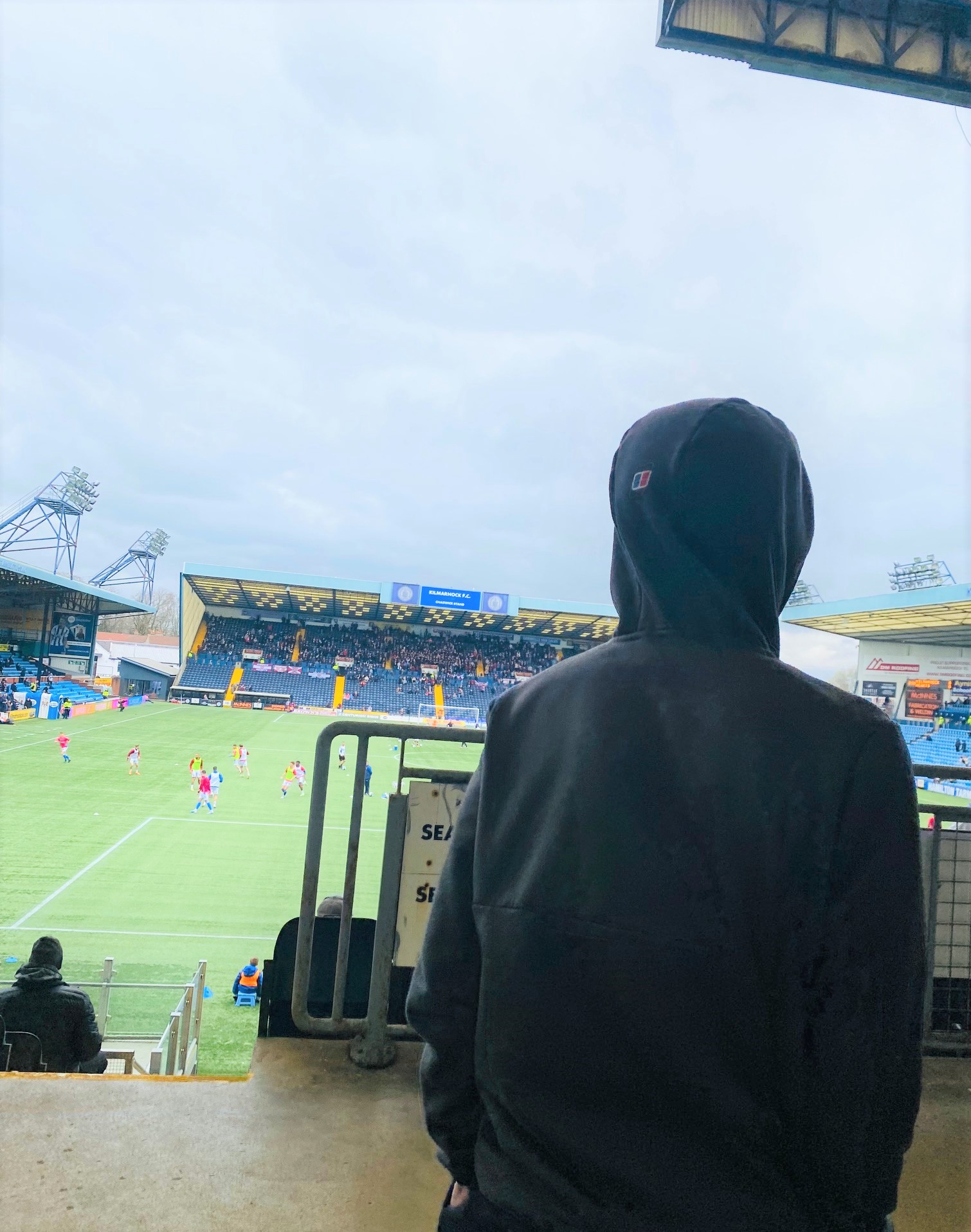 A young person enjoying a football match at Rugby Park