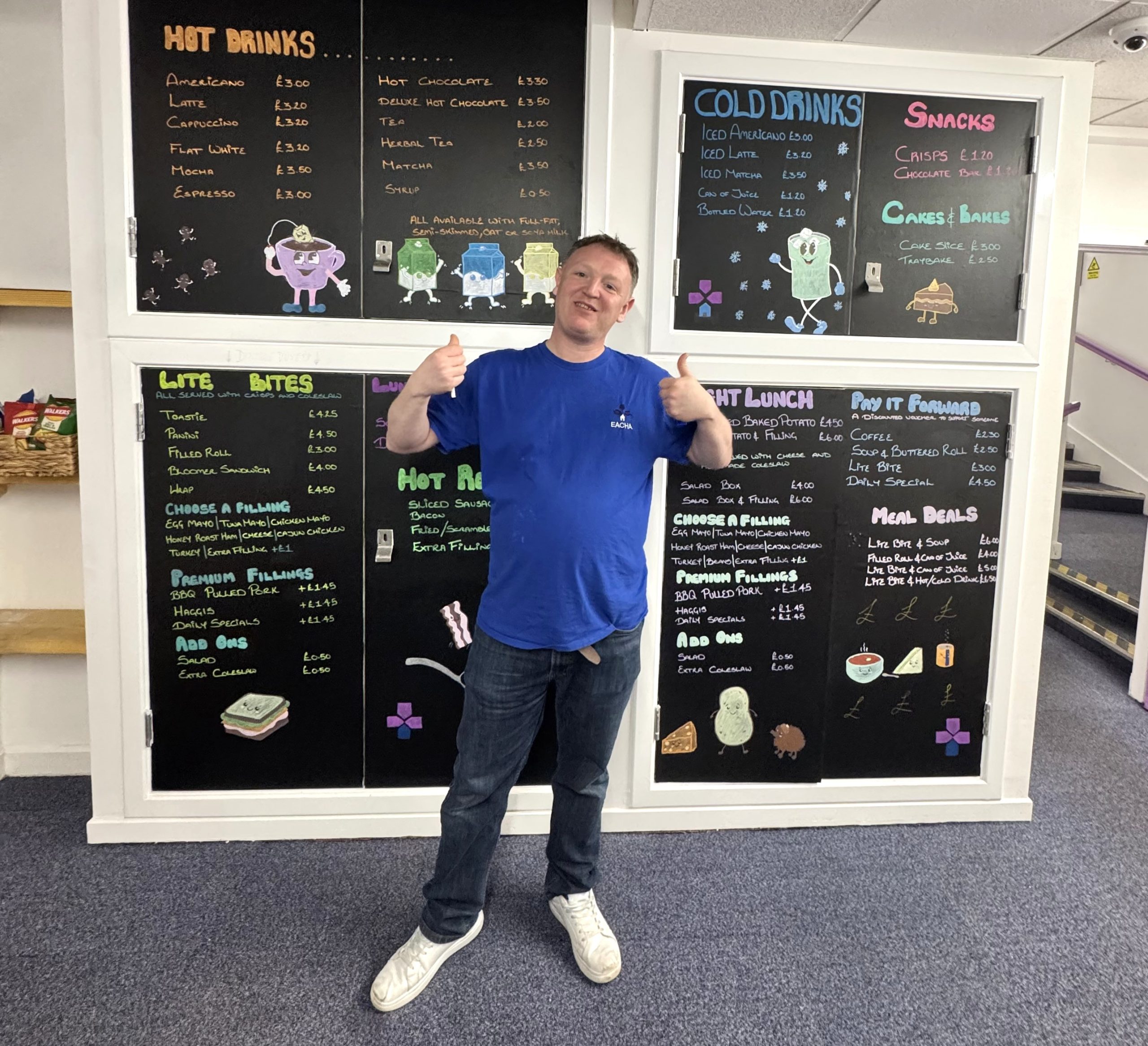 A member of staff in front of the specials board at the recently opened cafe
