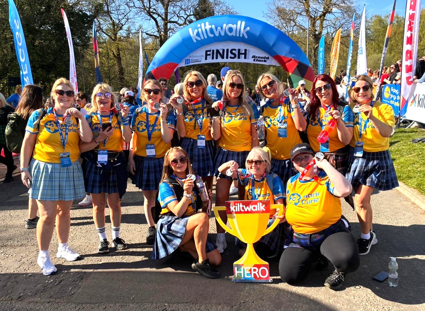 The social work team proudly standing at the Kiltwalk finish line.